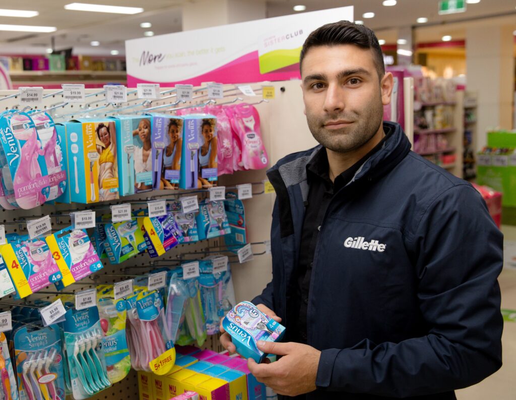 Gillette team member with shelf display